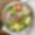The Cobb Salad includes seasoned chicken, blue cheese, red onion, avocado, cherry tomatoes, BACON and boiled eggs served on romaine lettuce and topped with Ranch dressing.