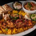 Basmati rice, chicken skewer, veggie skewer, dipping sauce, side of choice and warm pita slices.