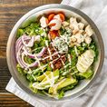 The Cobb Salad includes seasoned chicken, blue cheese, red onion, avocado, cherry tomatoes, BACON and boiled eggs served on romaine lettuce and topped with Ranch dressing.